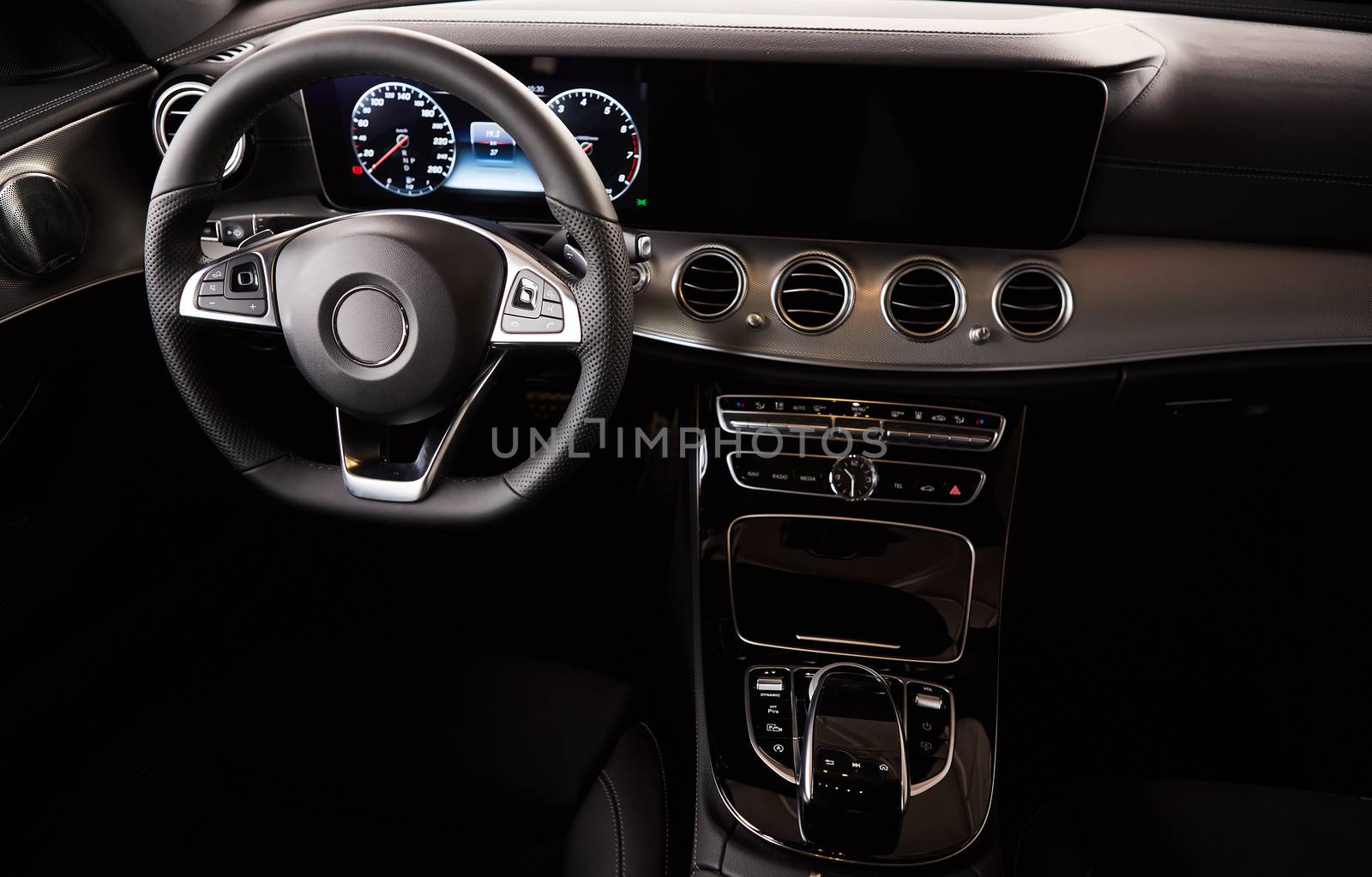 Luxury car Interior. Steering wheel and dashboard