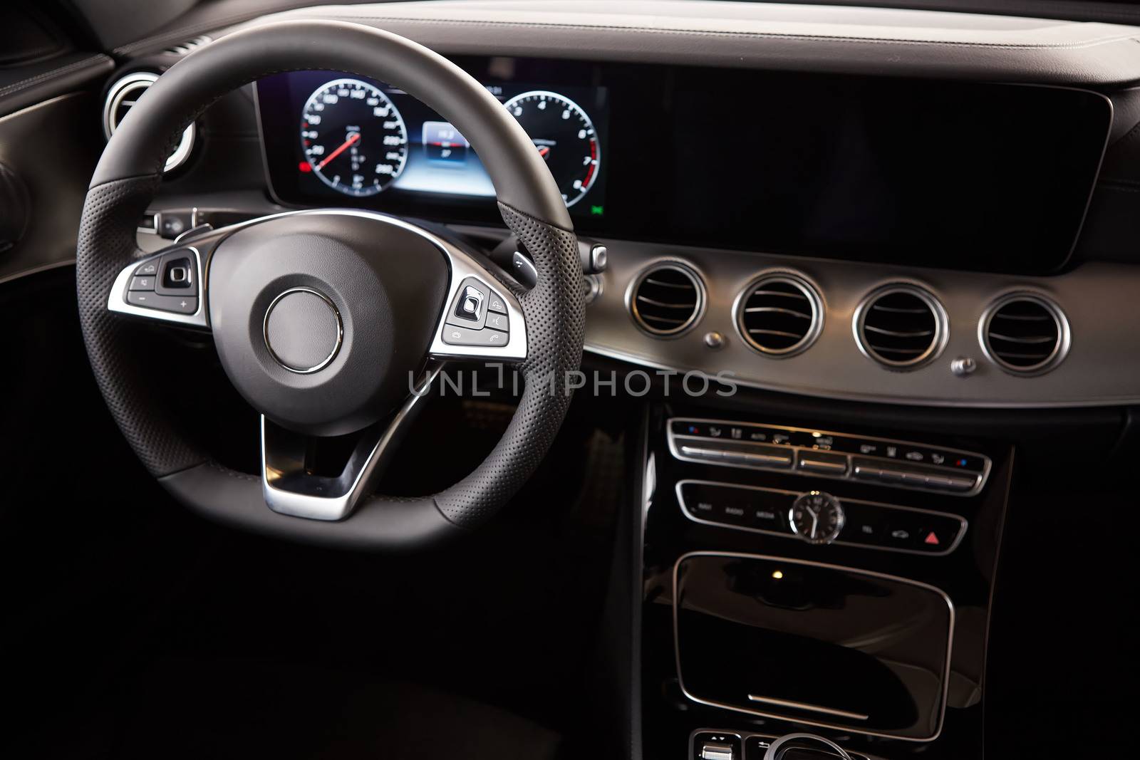 Luxury car Interior. Steering wheel and dashboard