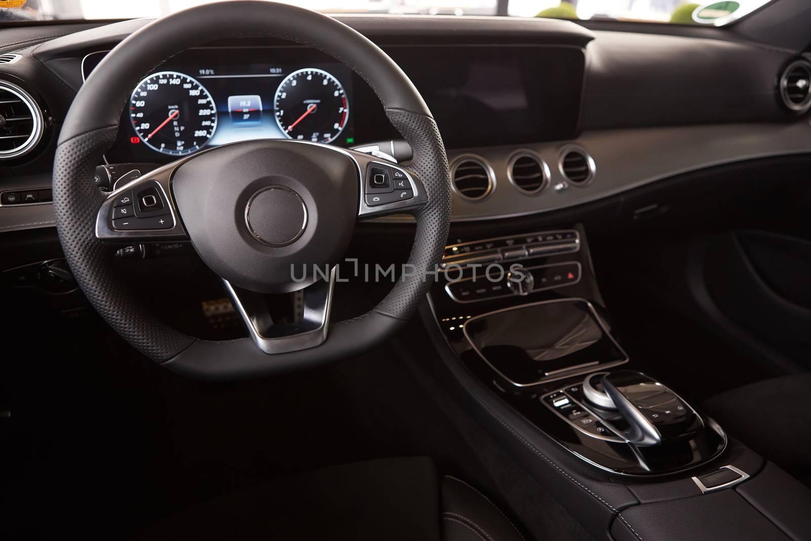 Luxury car Interior. Steering wheel and dashboard