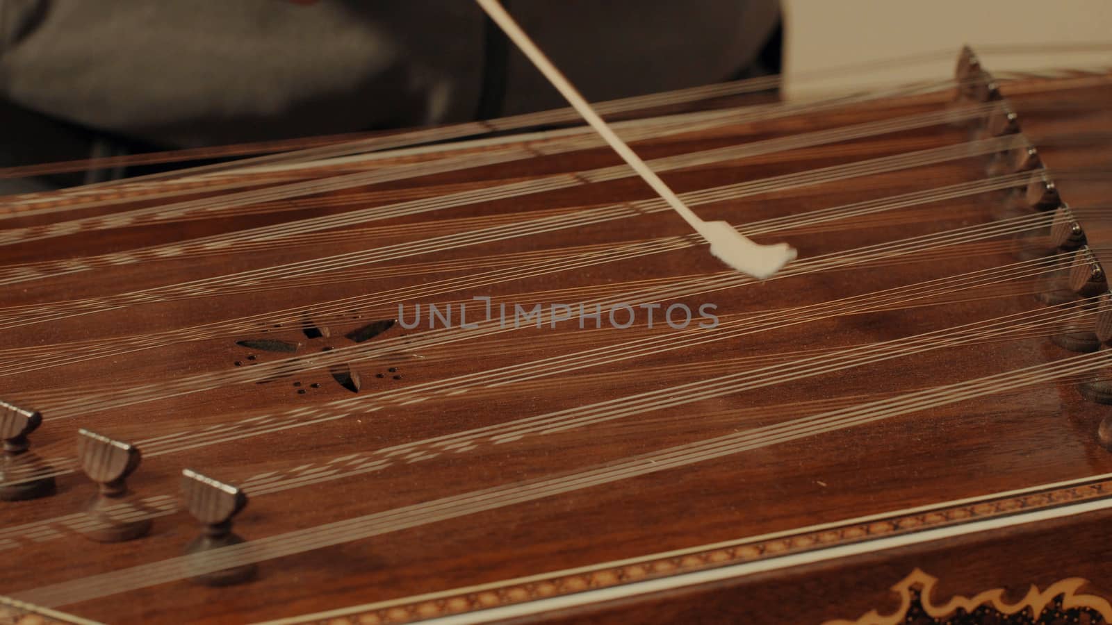 Someone is playing the ethnic musical instrument - santur. Close up