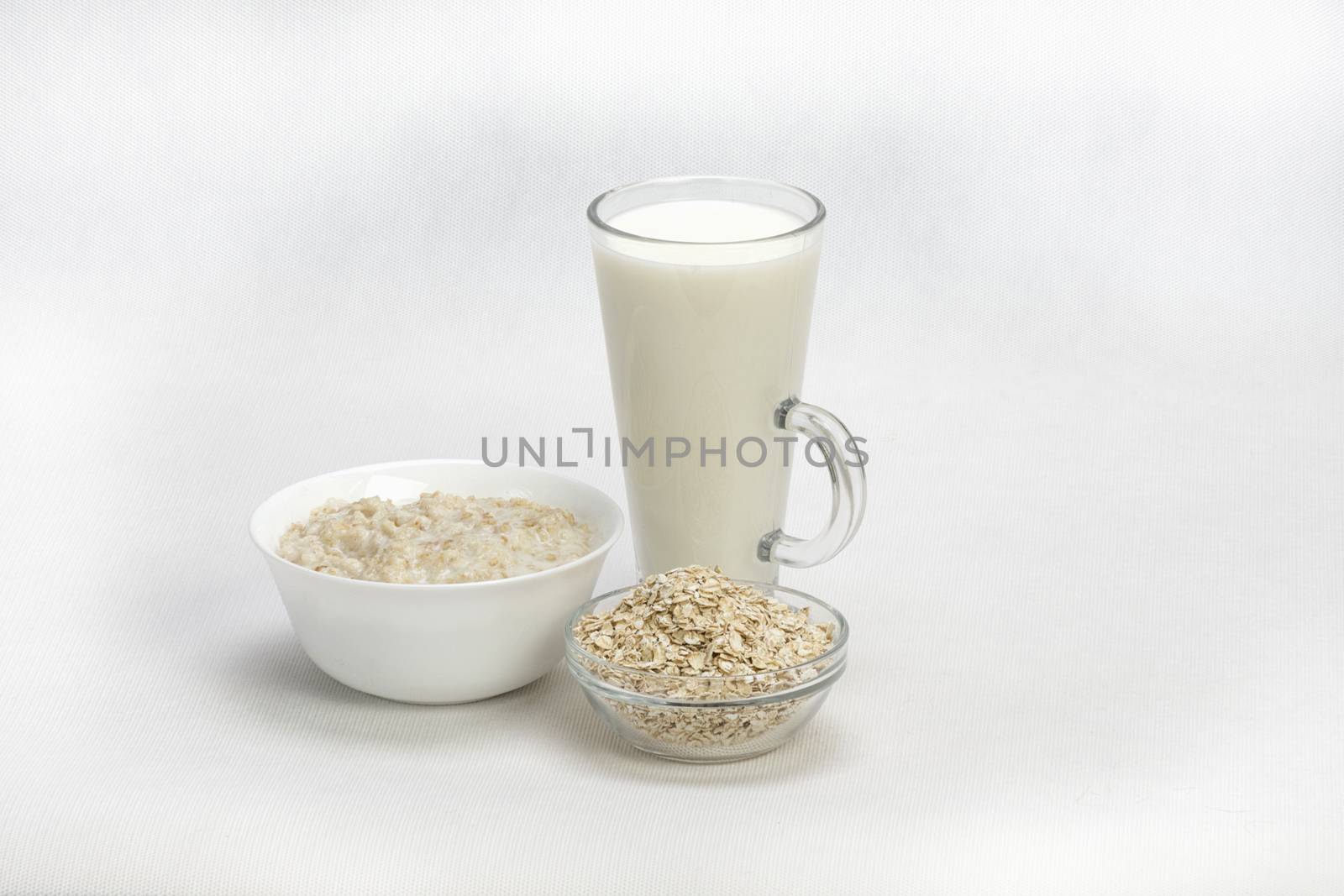 Bowl of oats porridge isolated on a white background Healthy breakfast