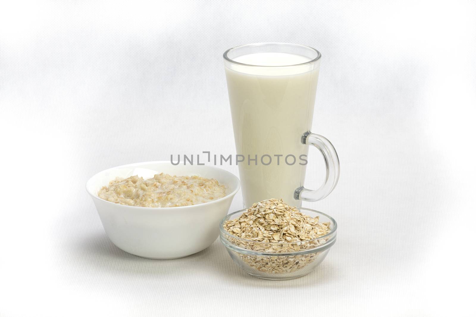 Bowl of oats porridge isolated on a white background Healthy breakfast