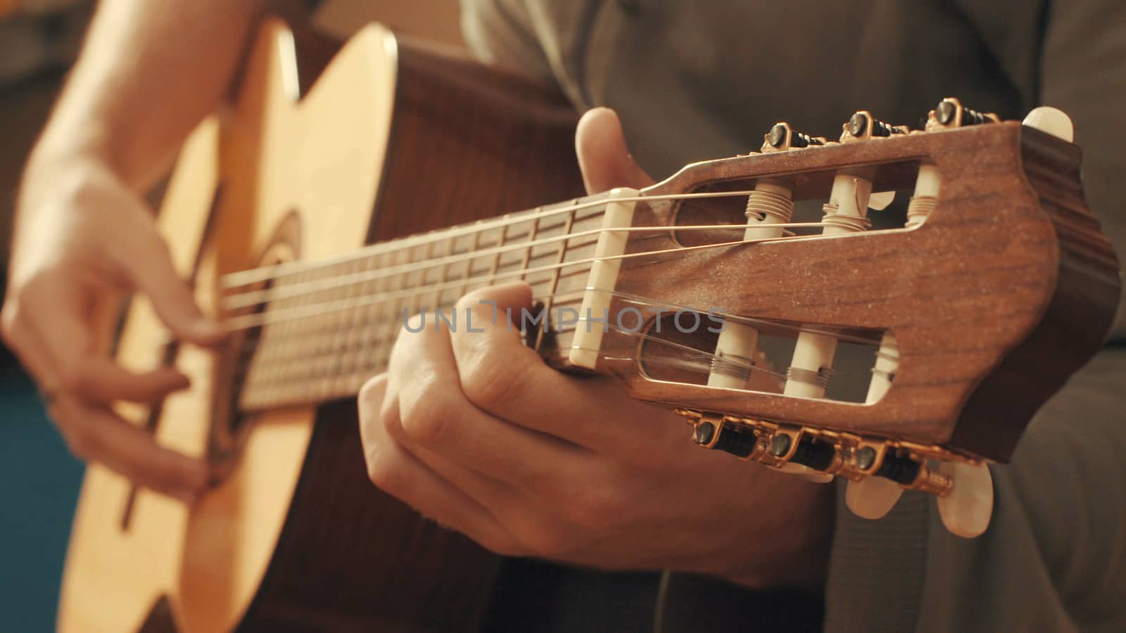 Hands of guitarist playing a guitar by Chudakov