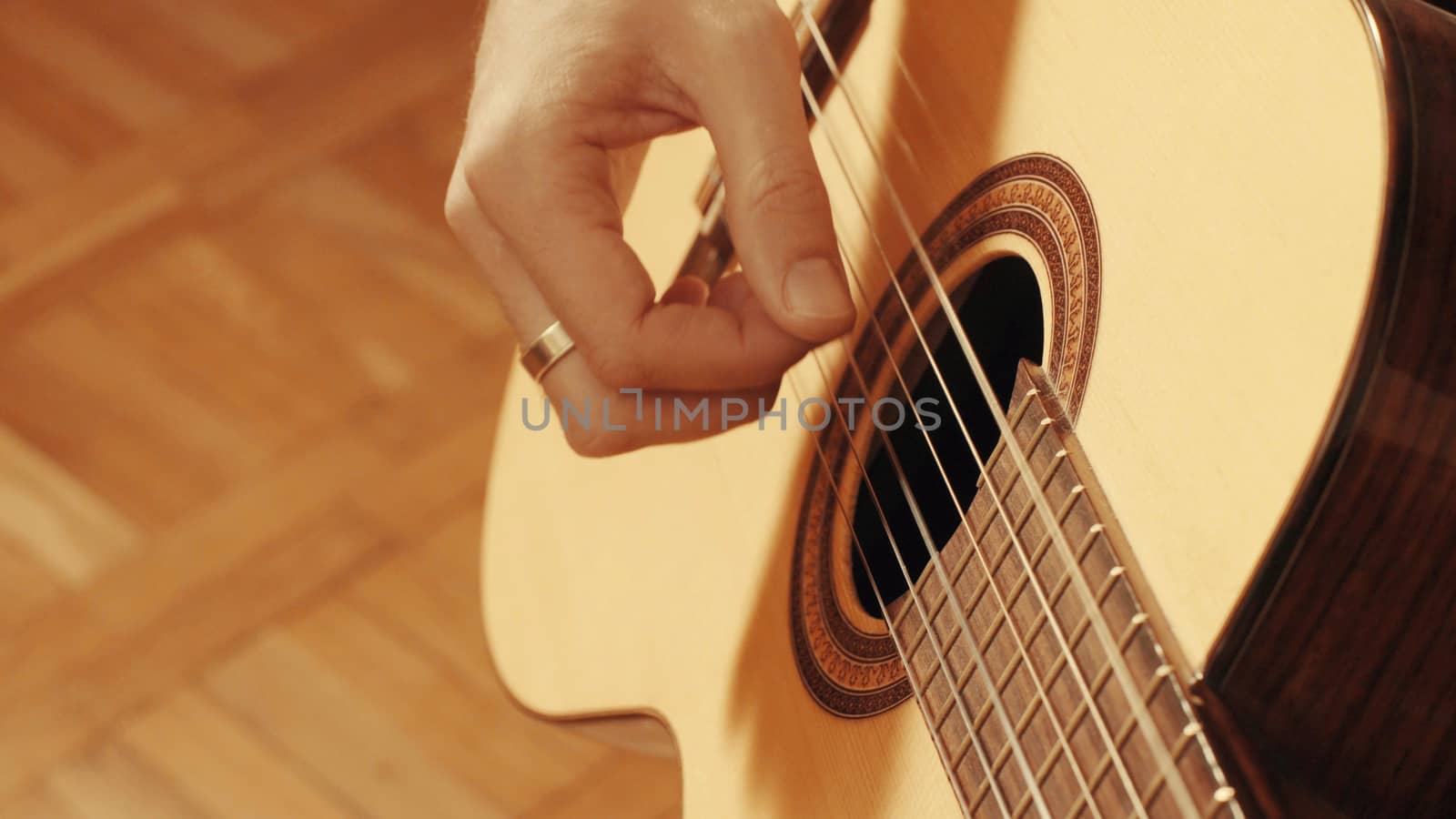 Hands of guitarist playing a guitar. Close up