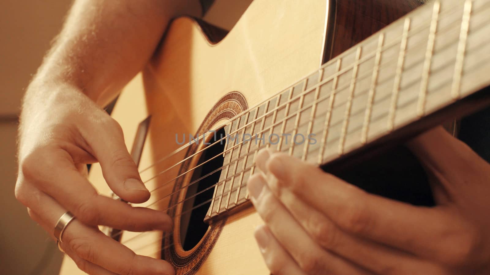 Hands of guitarist playing a guitar. Close up