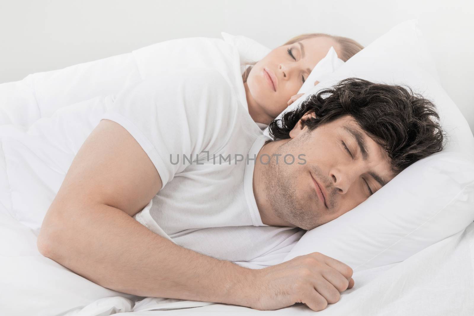 Portrait of beautiful middle age couple sleeping in the bed