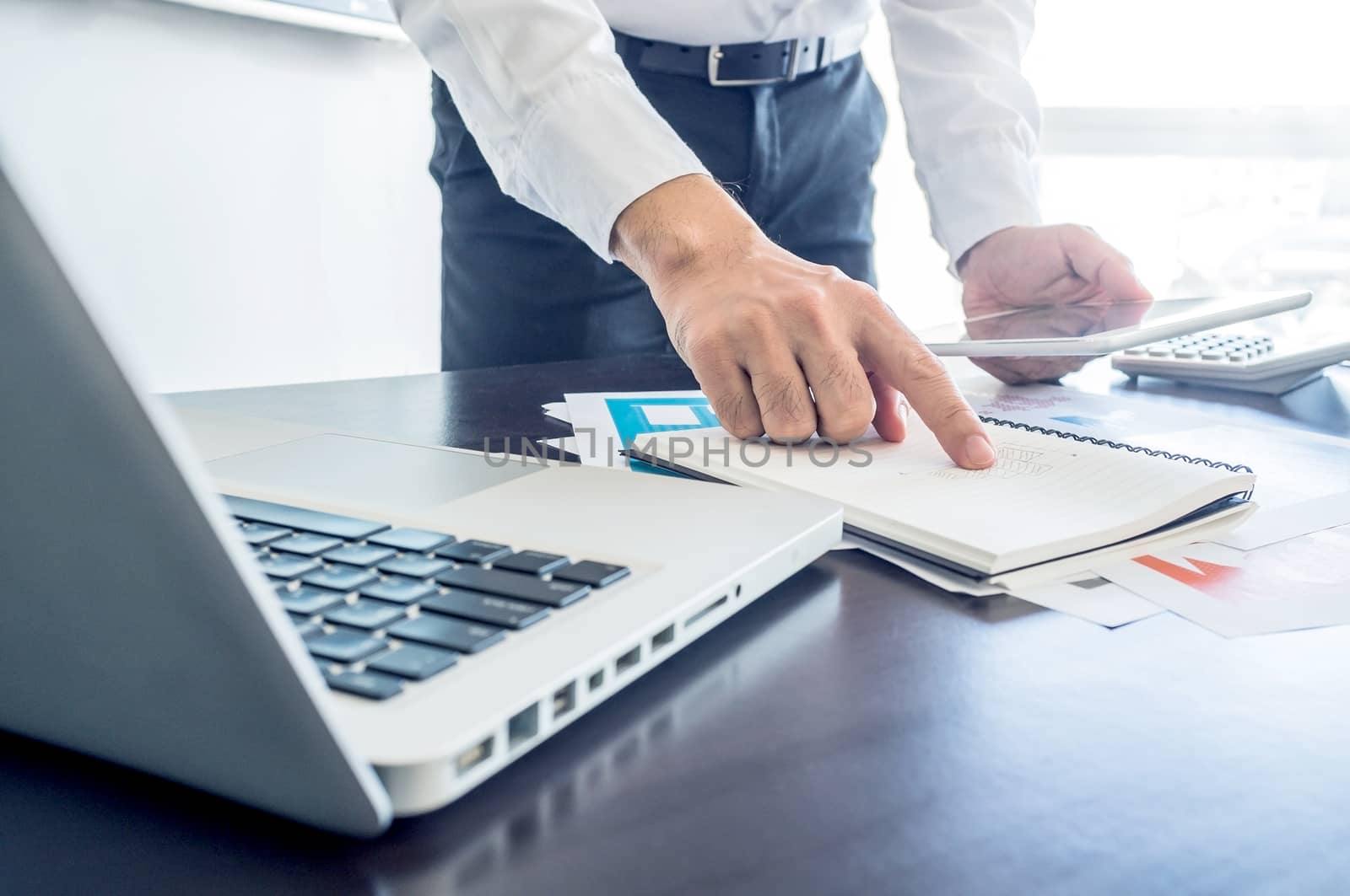 businessman working with digital tablet and laptop with financia by koson