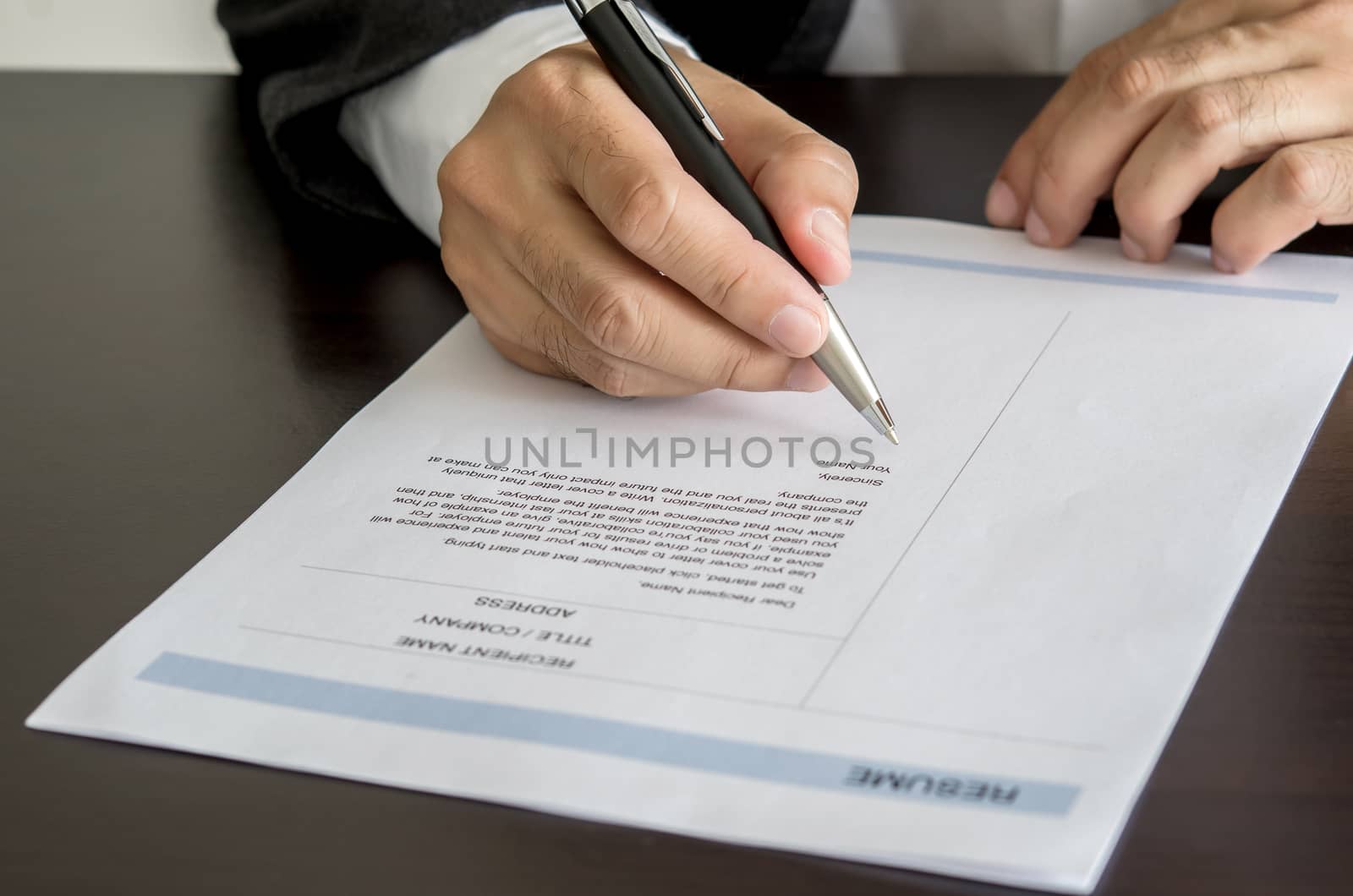 Businessman or job seeker signing on resume form. by koson