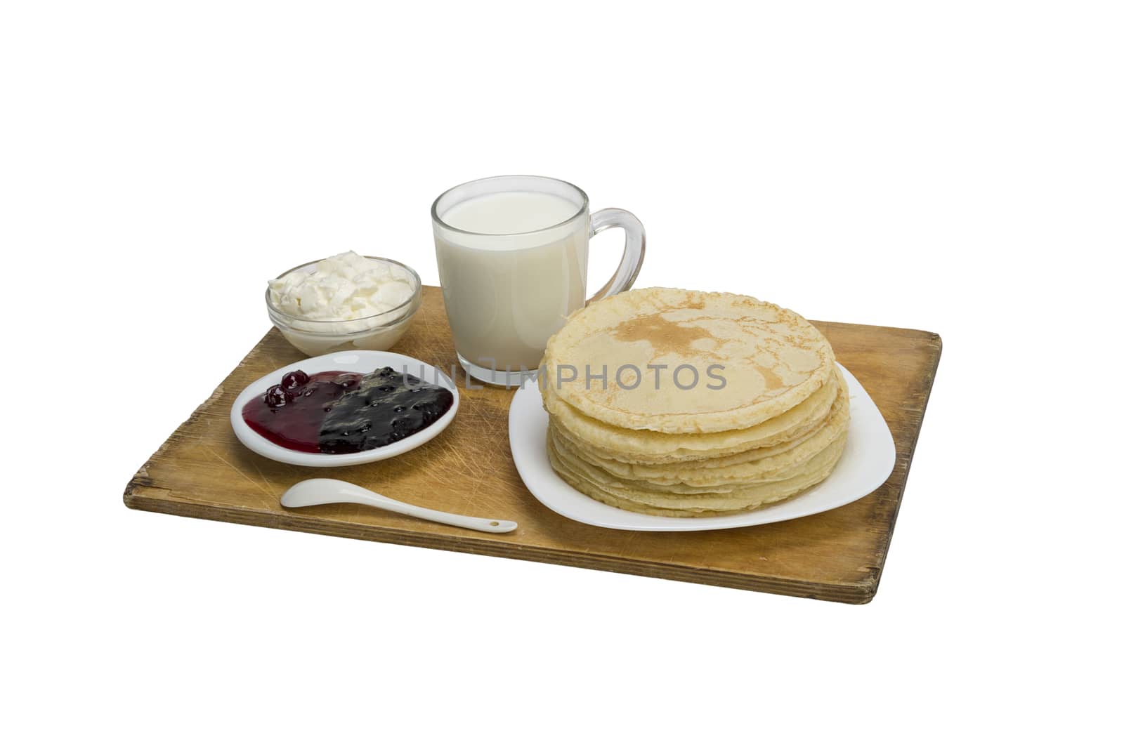 pancakes with jam and milk smeranoy on a wooden plank