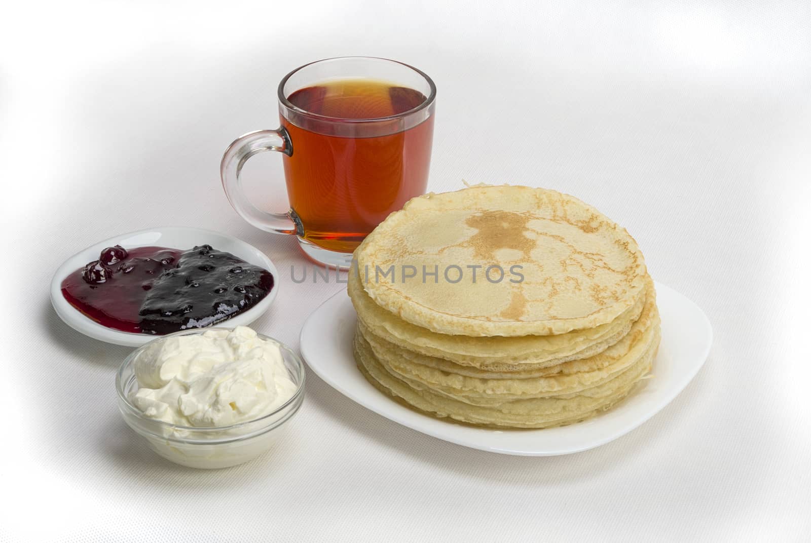 pancakes with jam and milk smeranoy on a wooden plank