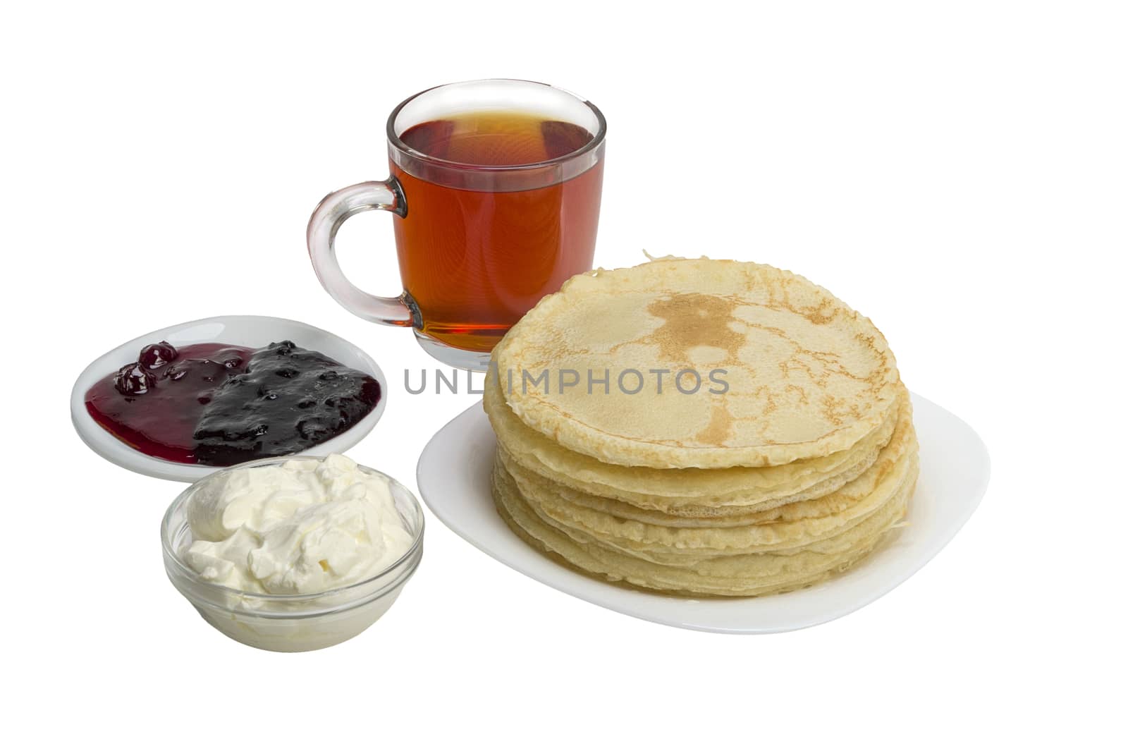pancakes with jam and milk smeranoy on a wooden plank