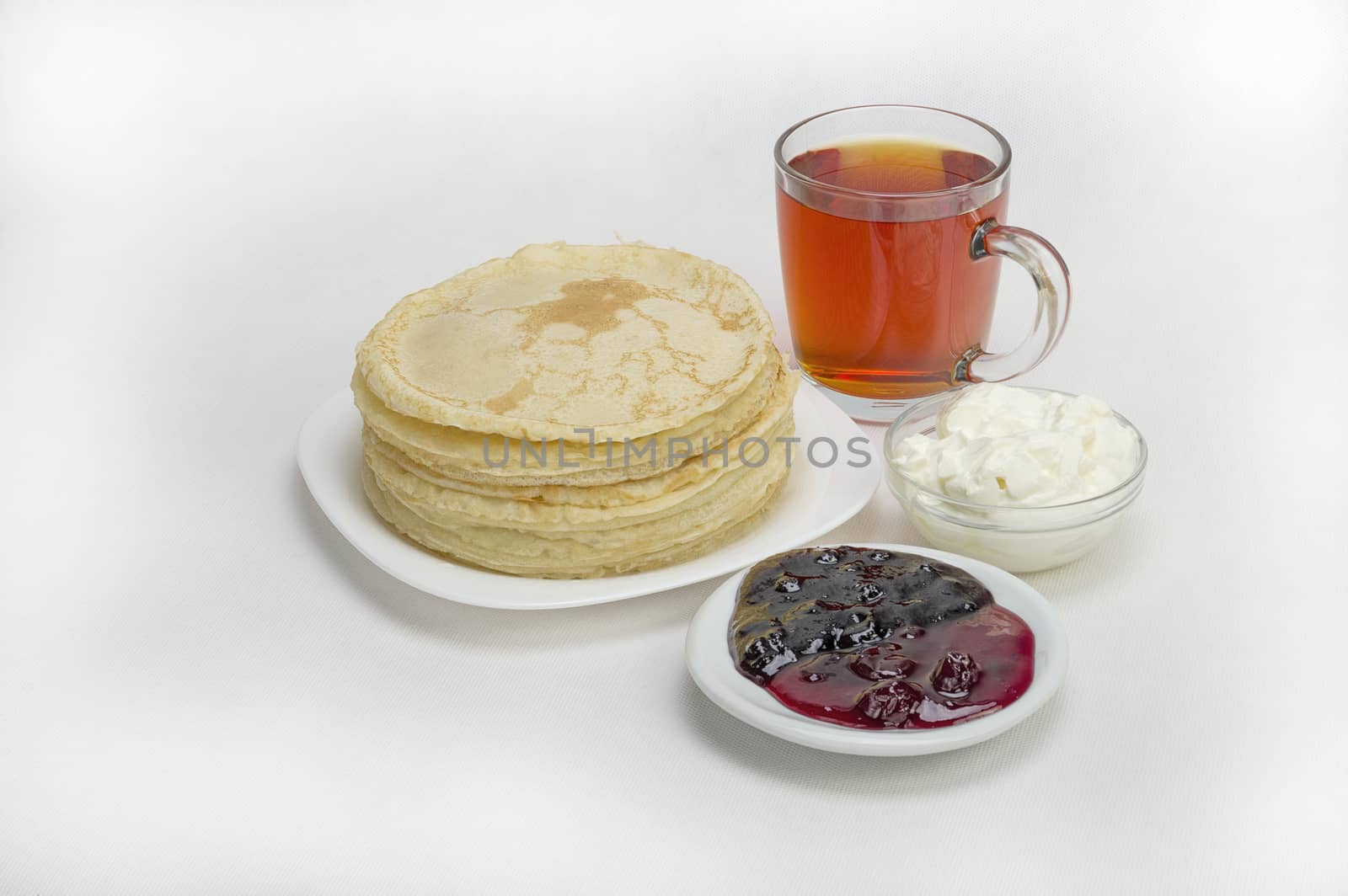 pancakes with jam and milk smeranoy on a wooden plank
