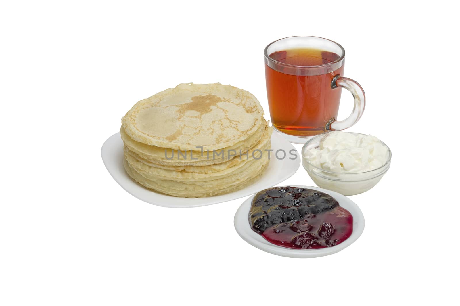 pancakes with jam and milk smeranoy on a wooden plank