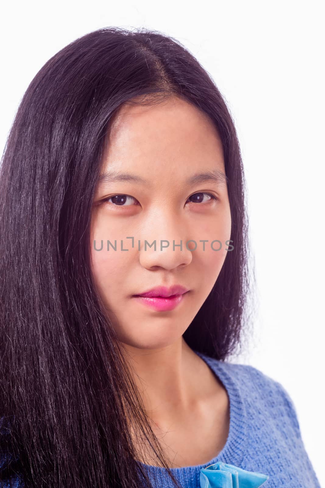 Portrait of Chinese teenage girl looking at camera, serious expression