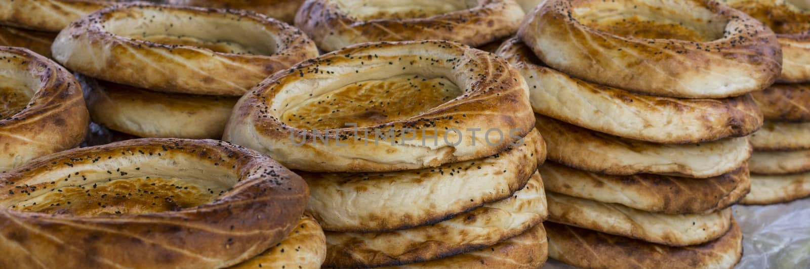Kirghiz bread tokoch on Sunday market in Osh. Kyrgyzstan. by mariusz_prusaczyk