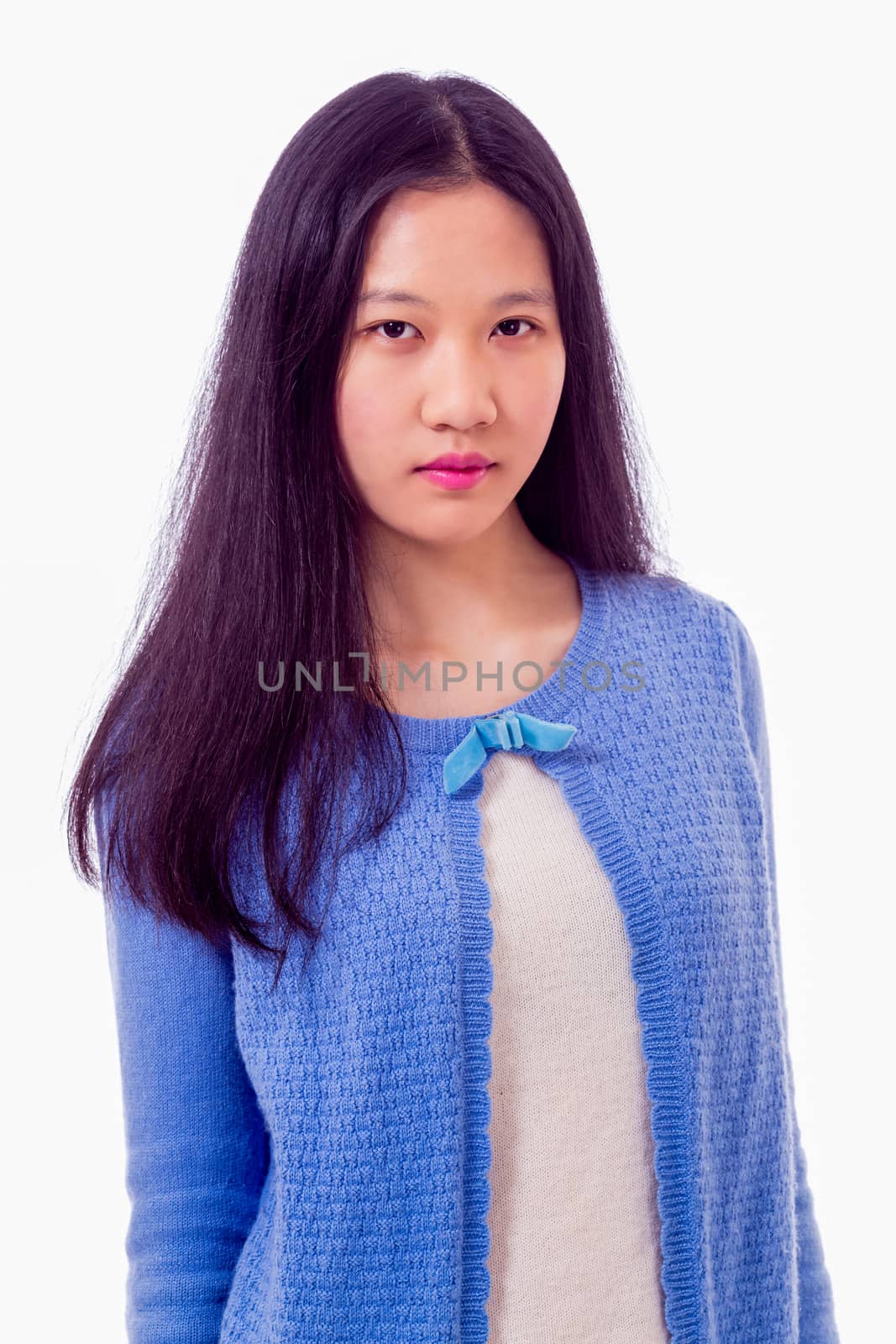 Portrait of Chinese teenage girl looking at camera, serious expression