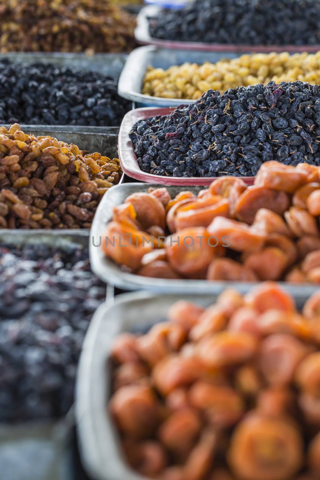 Dry fruits and spices like cashews, raisins, cloves, anise, etc. on display for sale in a bazaar in Osh Kyrgyzstan.