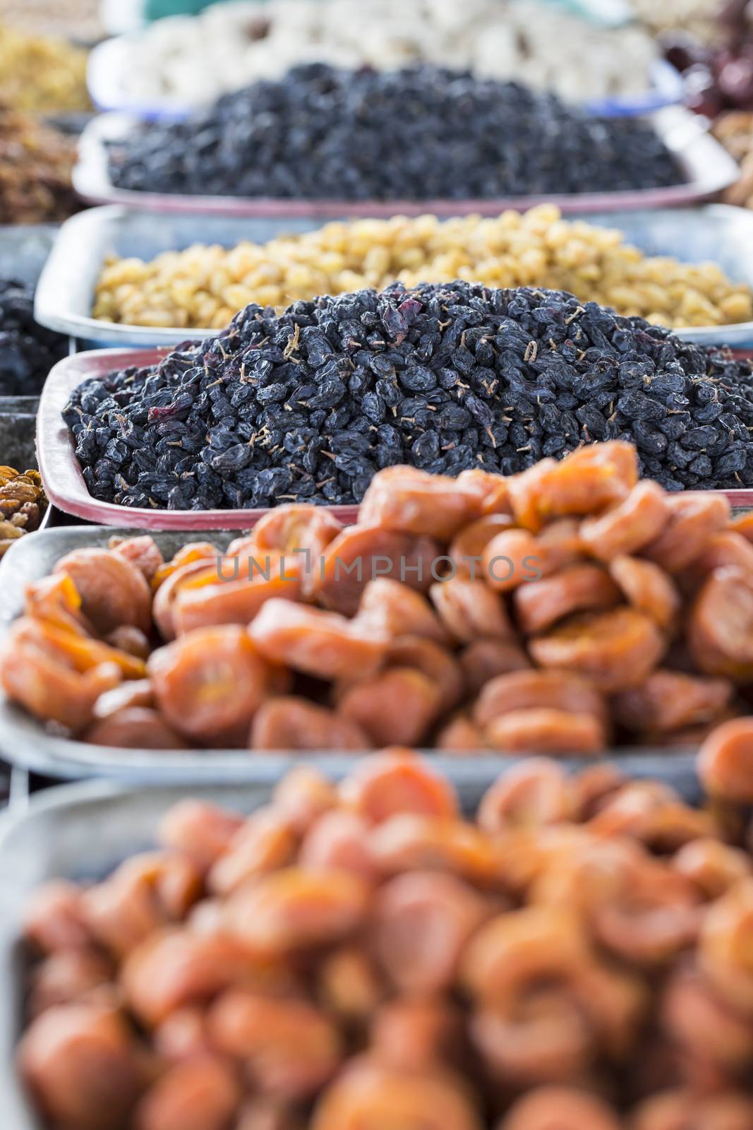 Dry fruits and spices like cashews, raisins, cloves, anise, etc. on display for sale in a bazaar in Osh Kyrgyzstan.