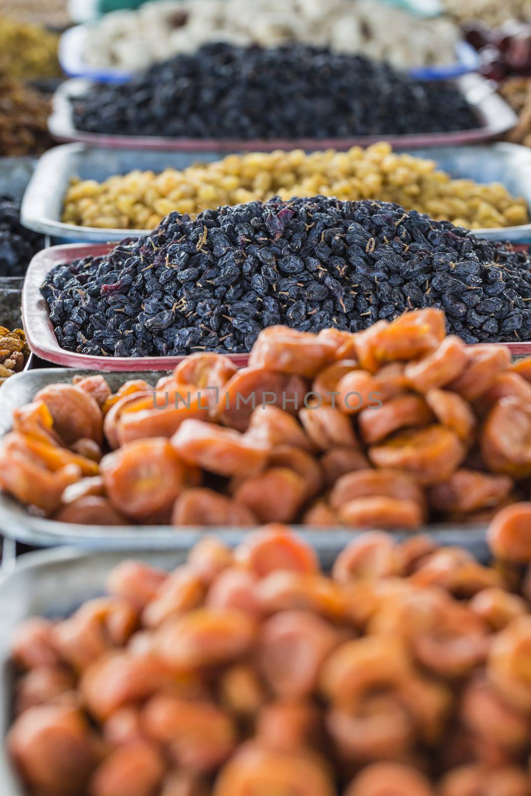 Dry fruits and spices like cashews, raisins, cloves, anise, etc. on display for sale in a bazaar in Osh Kyrgyzstan.