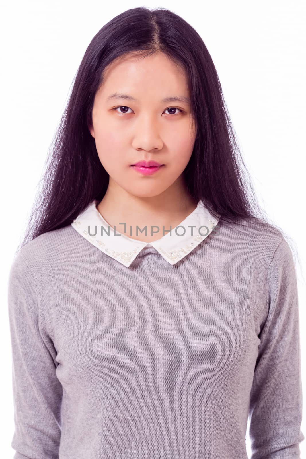 Portrait of Chinese teenage girl looking at camera, serious expression