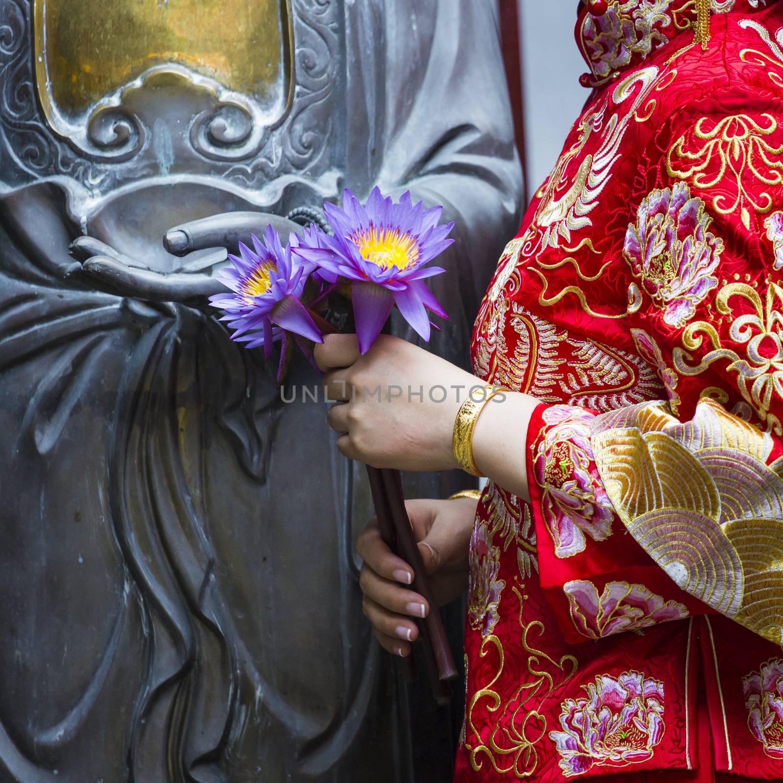 Woman hand respect to buddha statue. by mariusz_prusaczyk