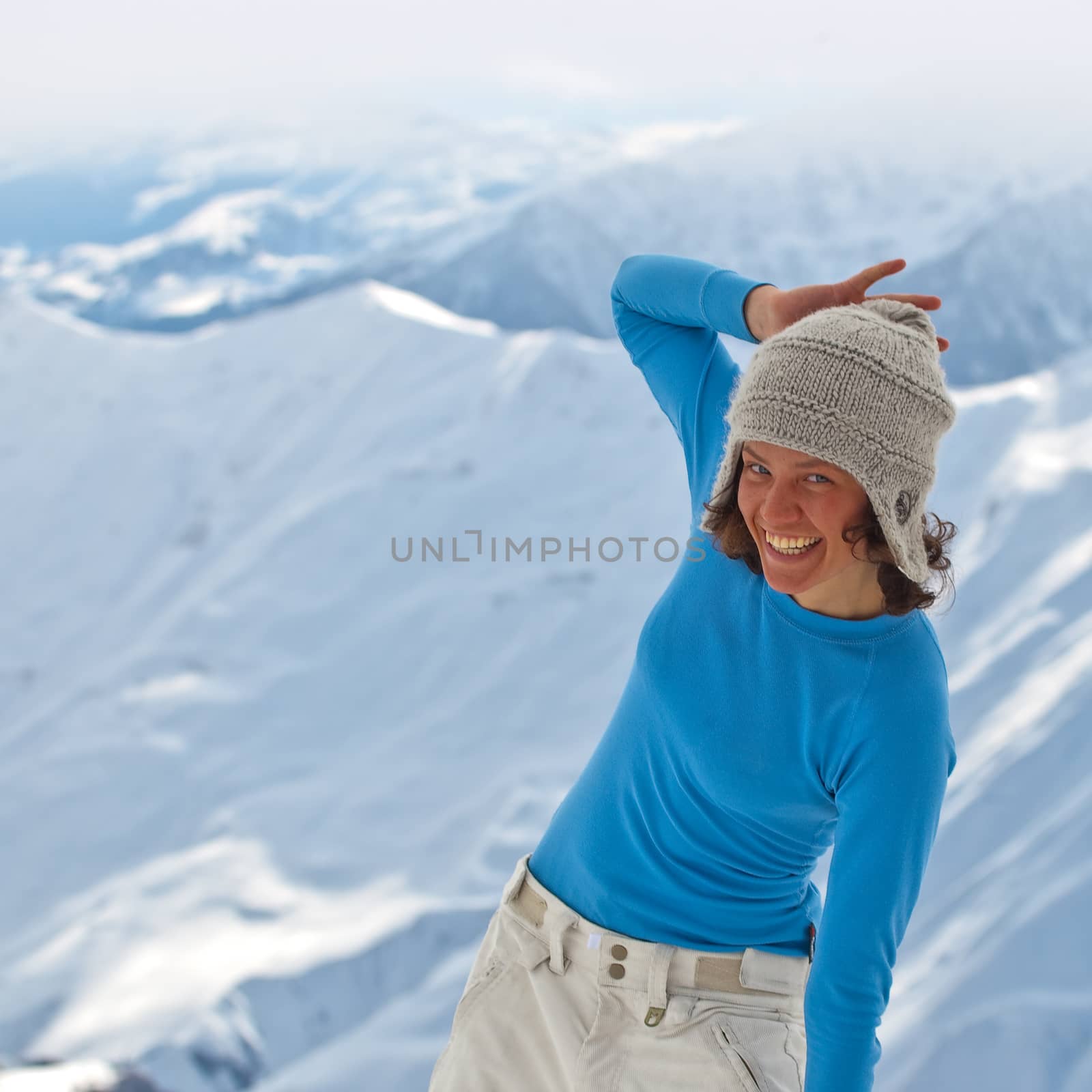 Young woman on the top of the mountain