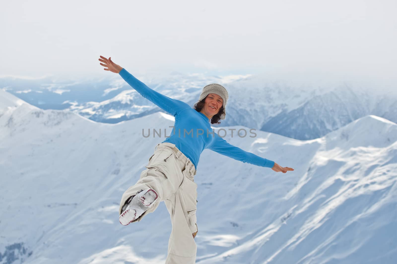 Young woman on the top of the mountain