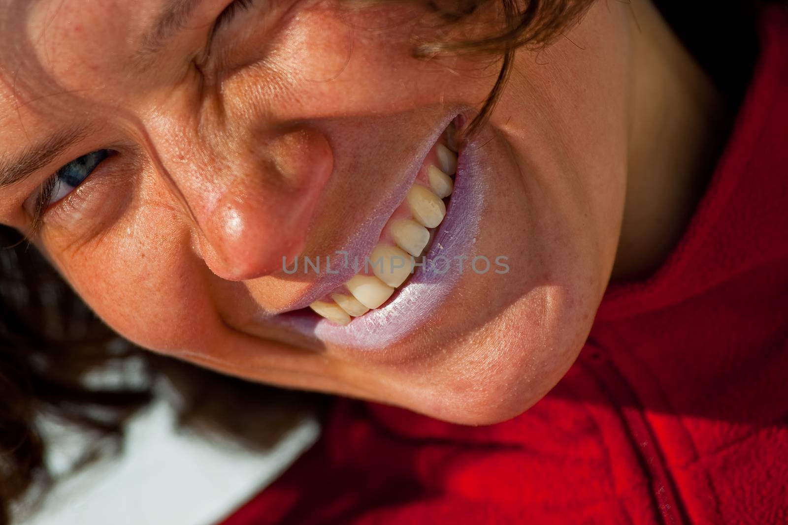 Close up of the nice girl, applicating the sunblock cosmetics.