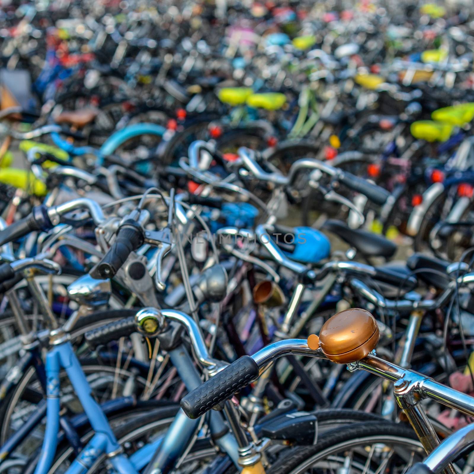 Detail Of Hundreds Of Bicycles In A Town In The Netherlands With A Bell In The Foreground