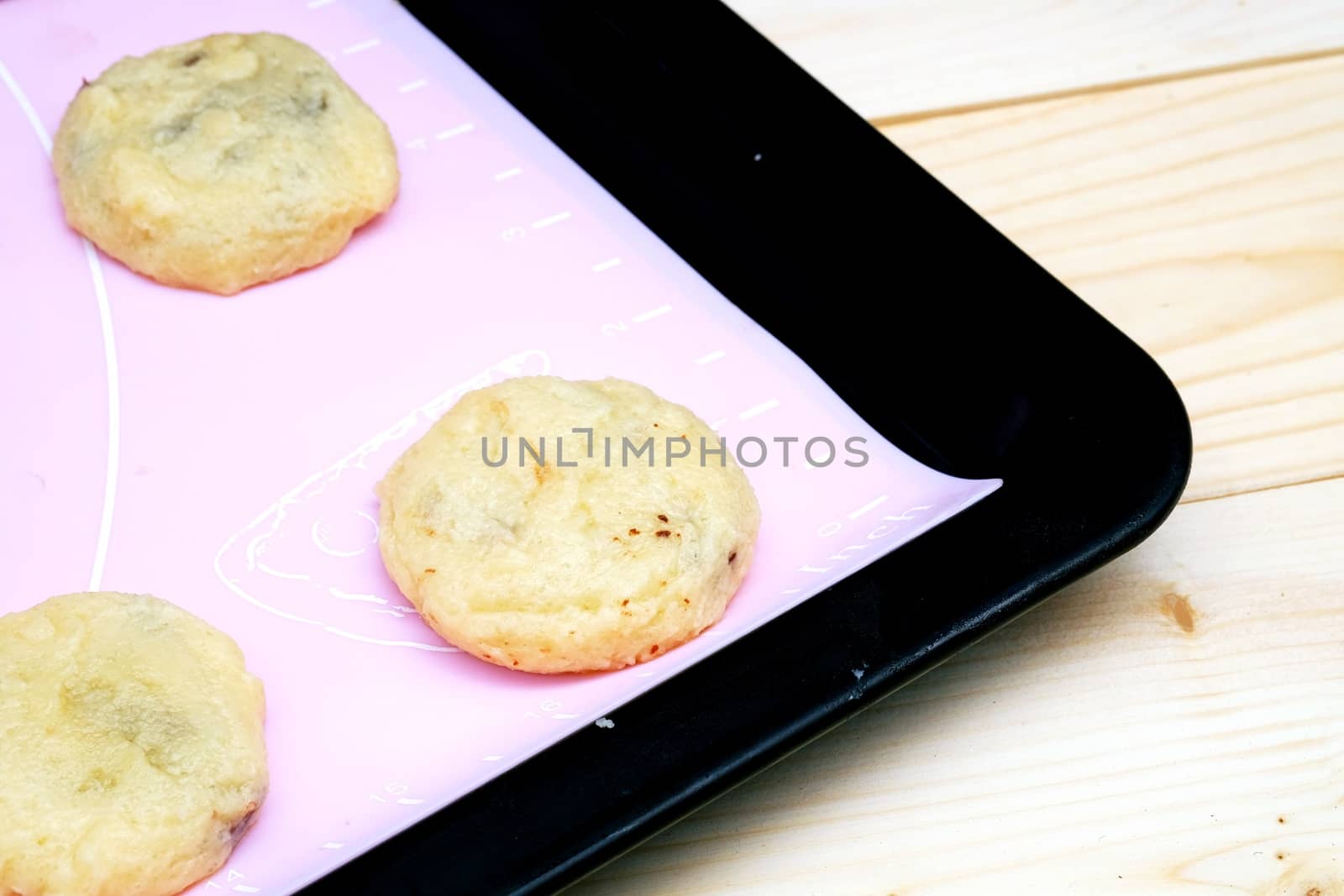 Cookies in baking tray on the table Wood