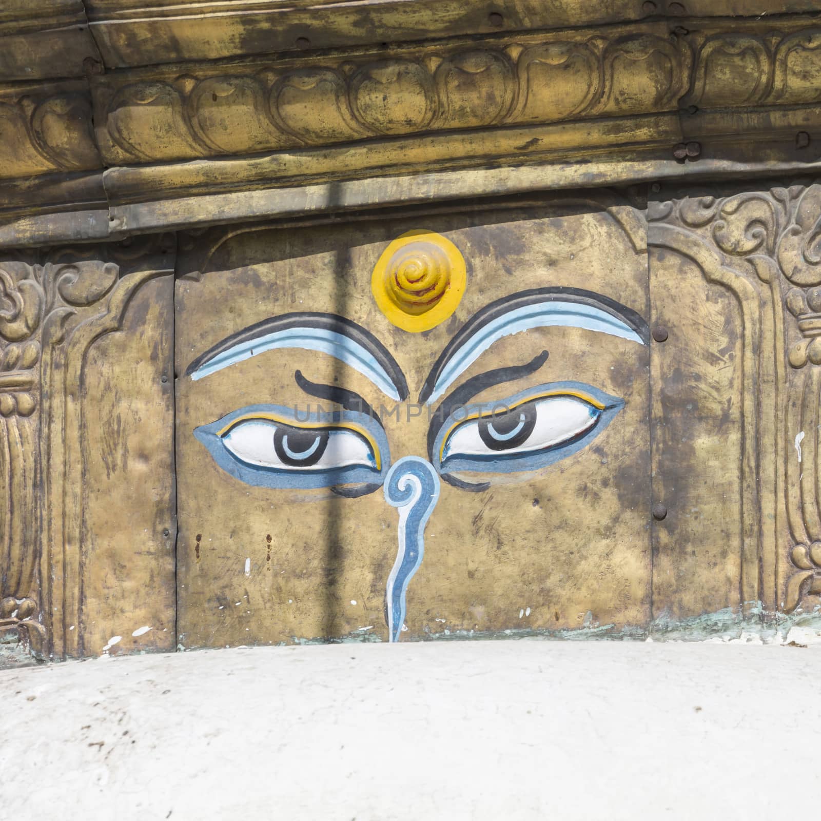 Buddha eyes close up with prayer flags at Bodhnath stupa in Kathmandu valley, Nepal

