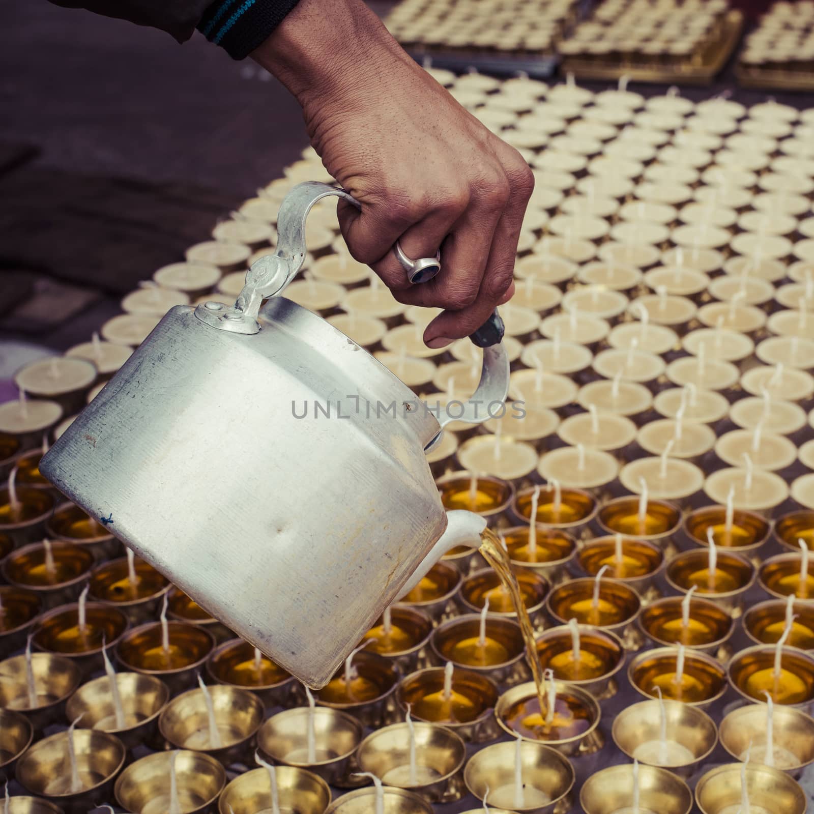 Candles and pot at Boudhanath stupa in Kathmandu, Nepal by mariusz_prusaczyk