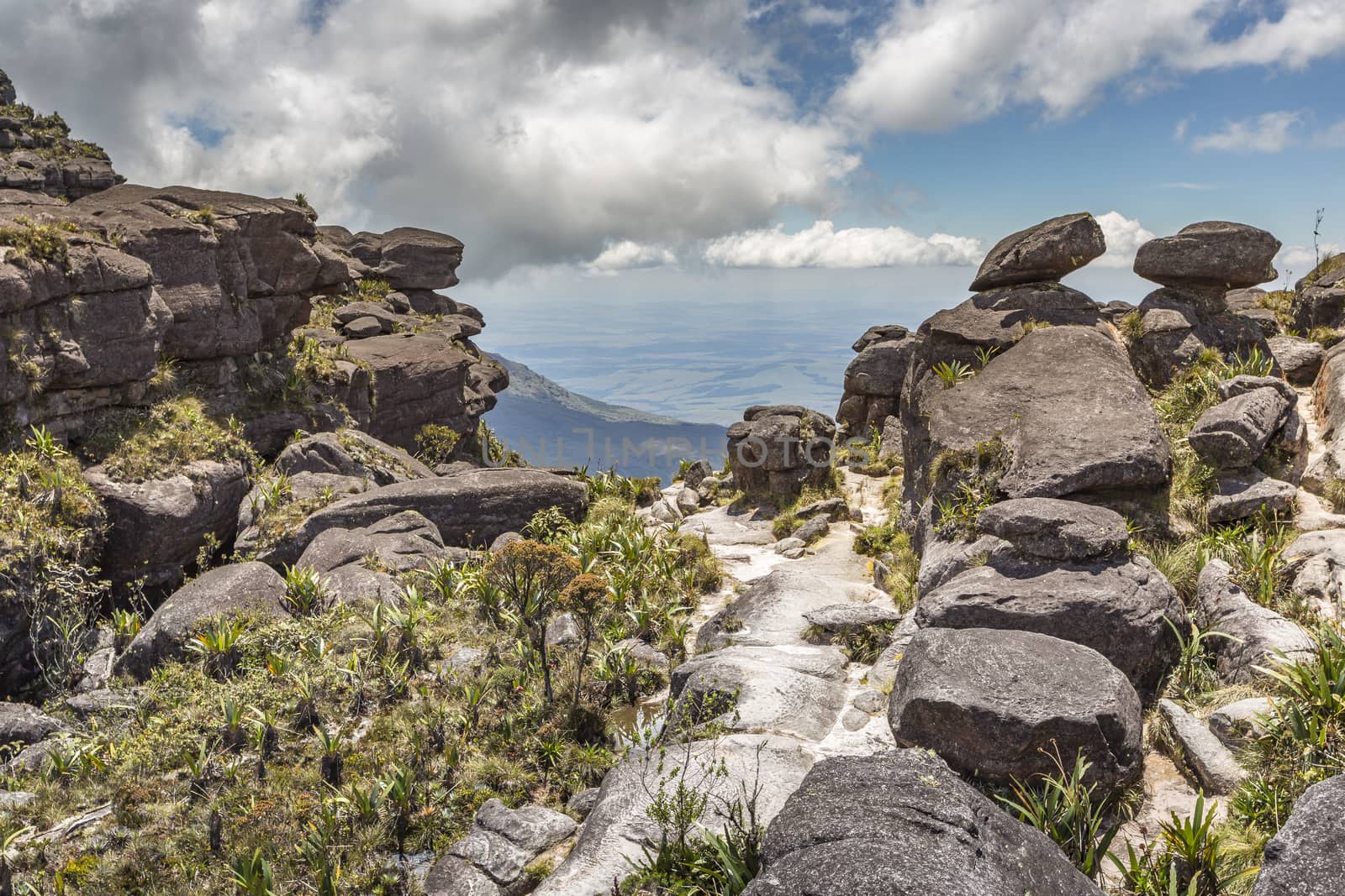 Trail down from the plateau Roraima passes under a falls - Venezuela, South America

