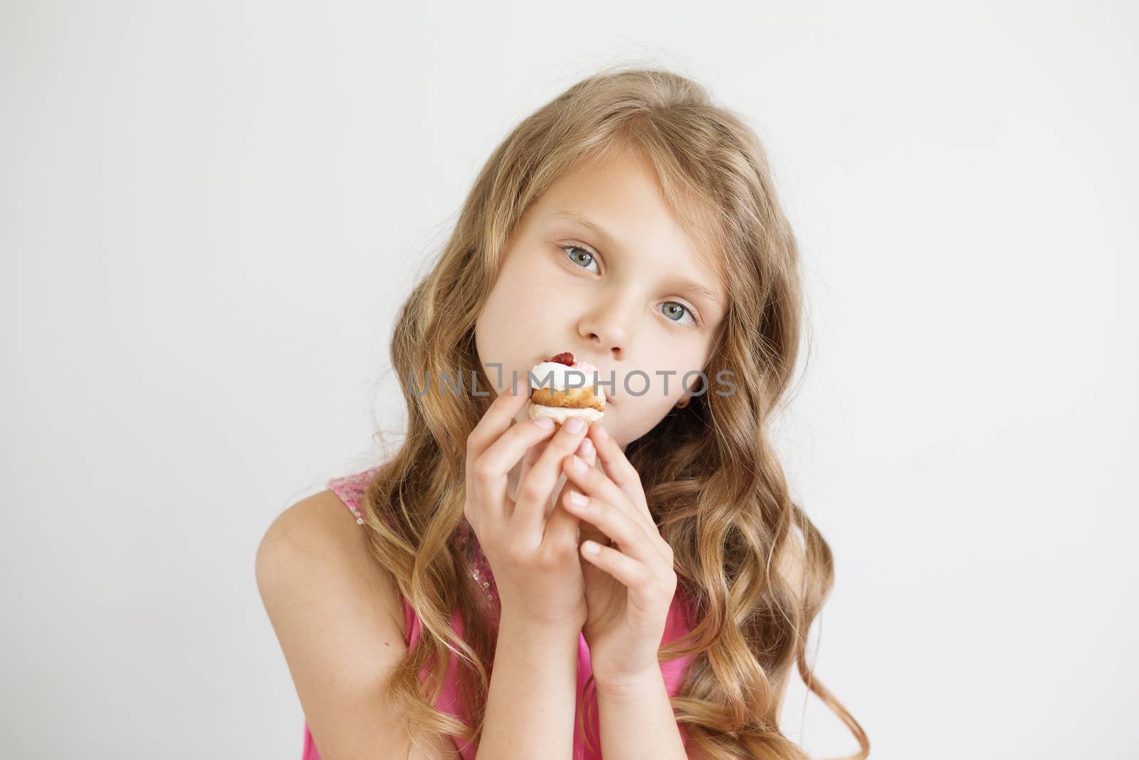 Beautiful little girl holding a delicious appetizing cake