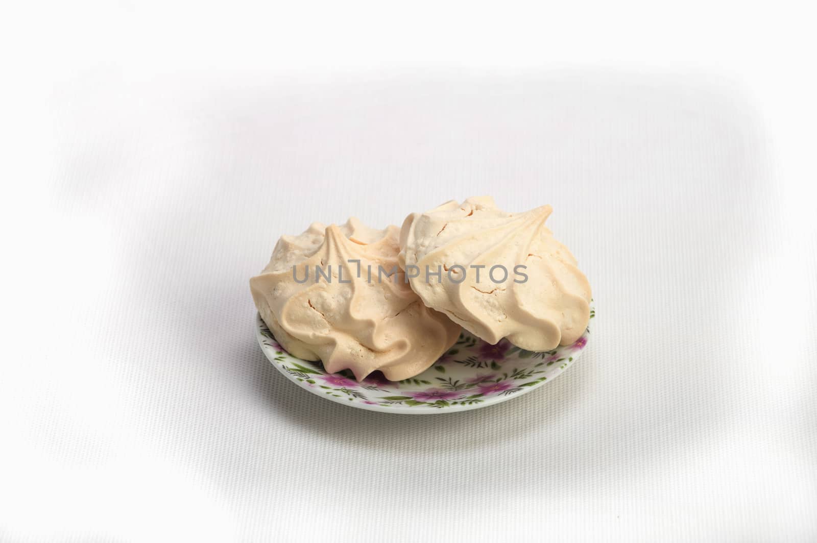 Fresh delicious meringue cookies served with tea or coffee macro