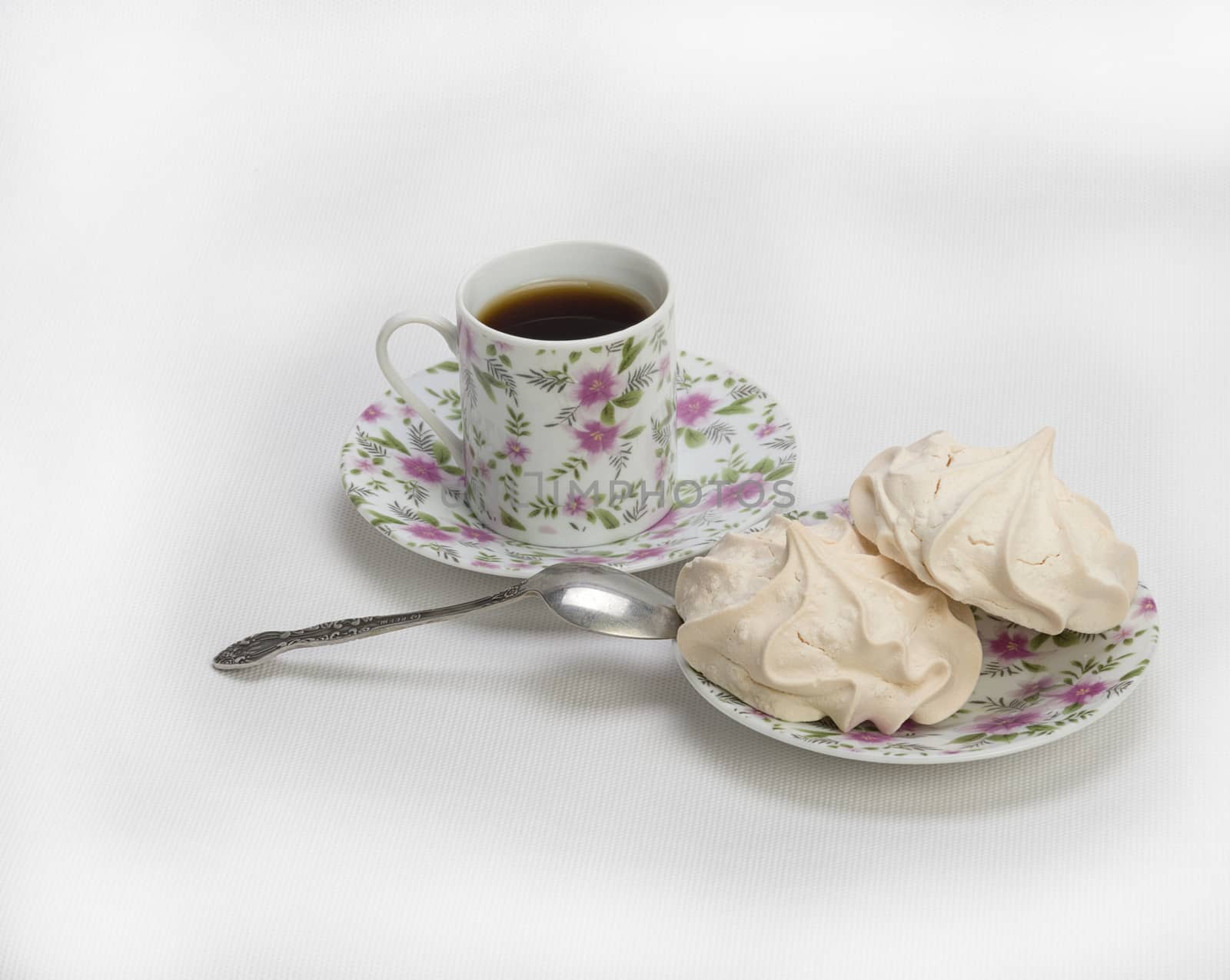 Fresh delicious meringue cookies served with tea or coffee macro