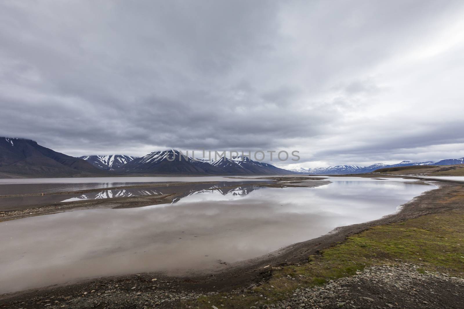 Beautiful scenic view of blue gulf under barren mountain range w by mariusz_prusaczyk