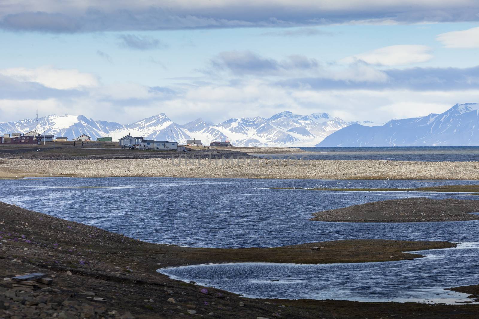 Beautiful scenic view of blue gulf under barren mountain range w by mariusz_prusaczyk