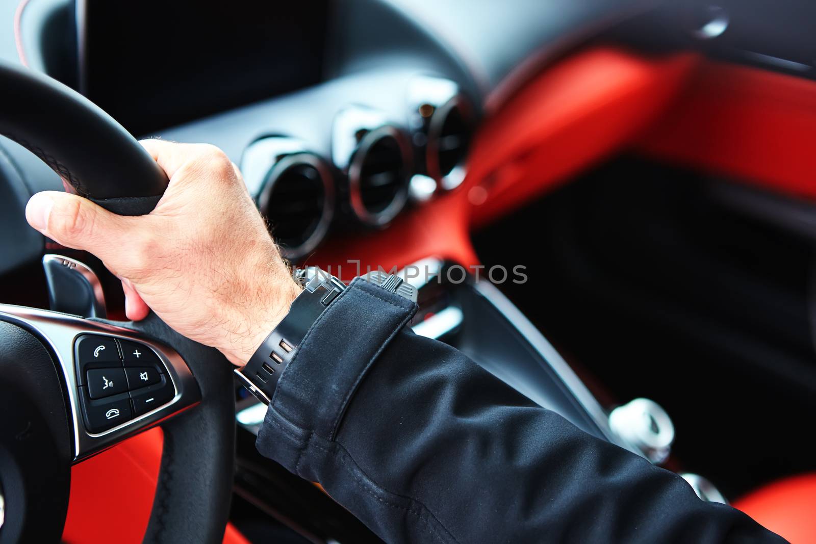 Male driver hands holding steering wheel. by sarymsakov