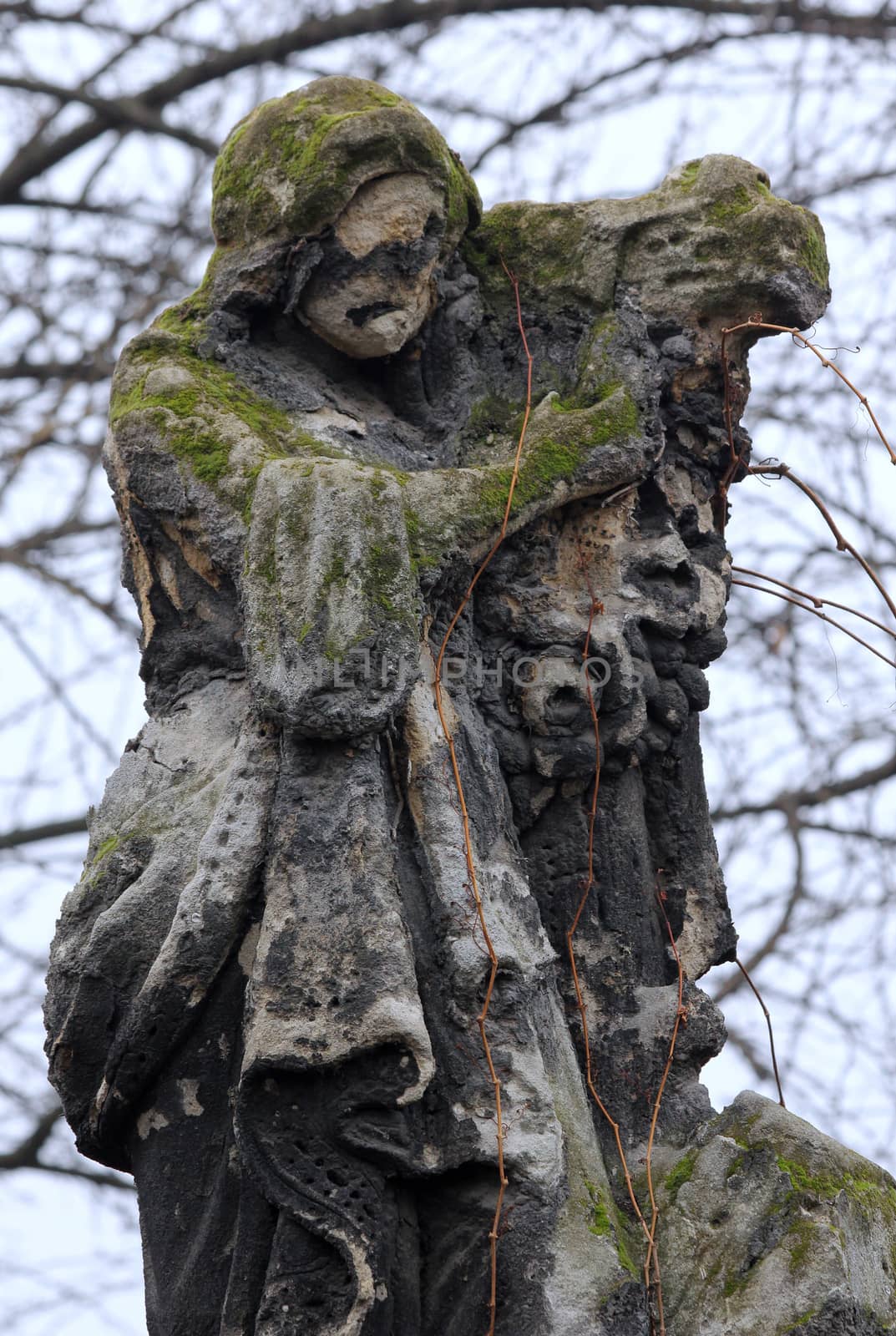 Eroded cemetery tombstone sculpture.