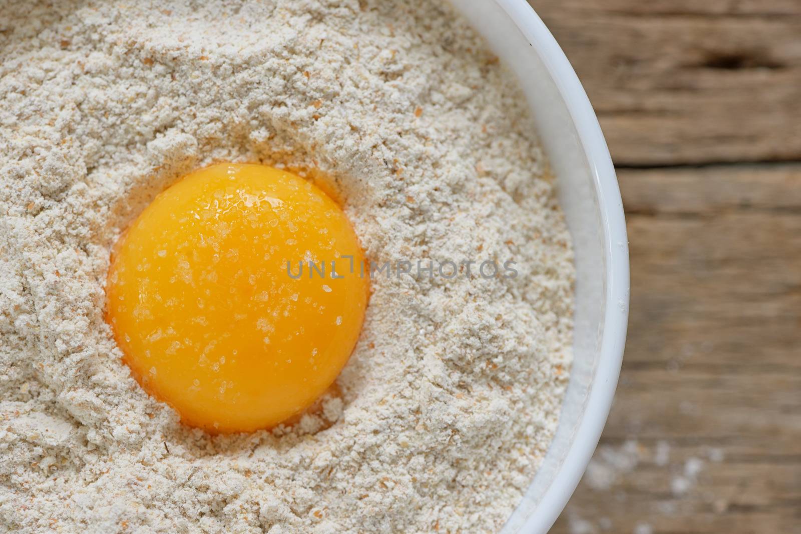 Flour and eggs ready for mixing on wooden table