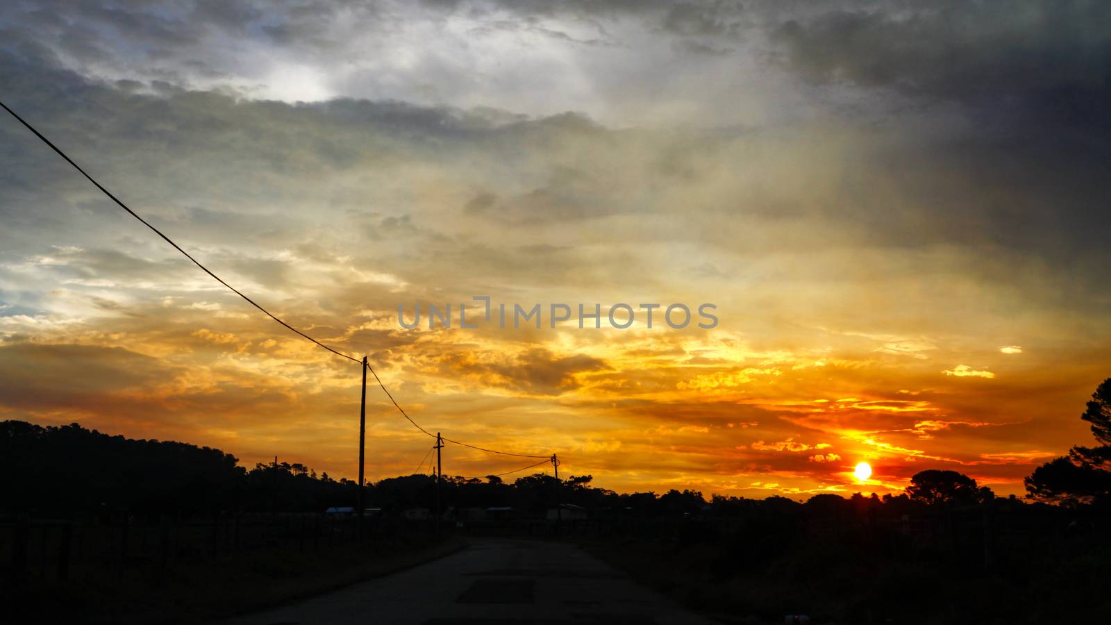 Yellow and orange sunset on the road trip by markdescande