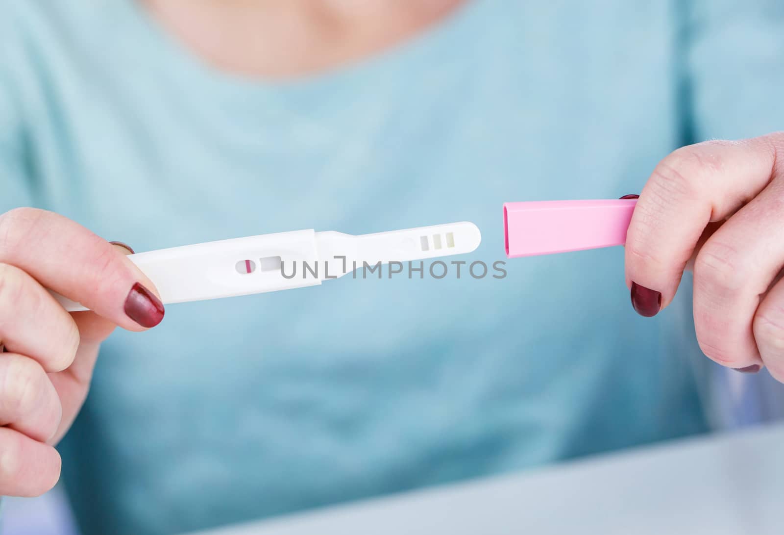 Young woman holding a Pregnancy Test in her hands