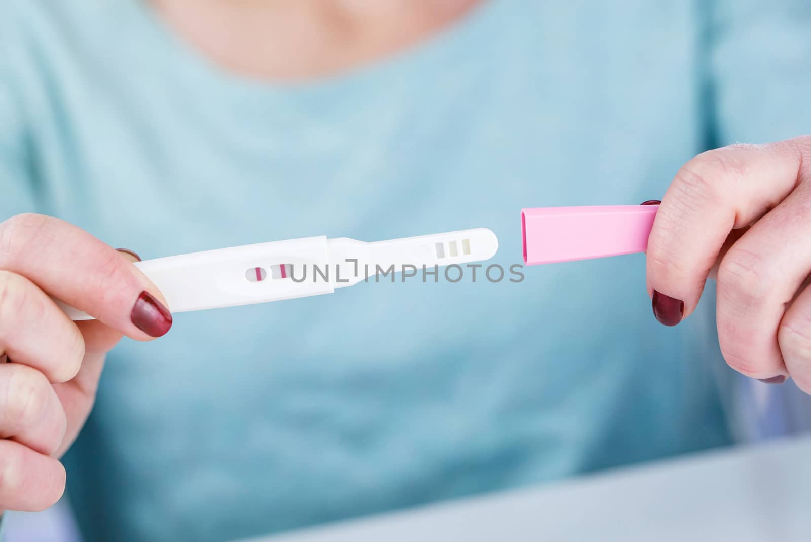 woman holding a Pregnancy Test pregnancy test positive result in by pixinoo