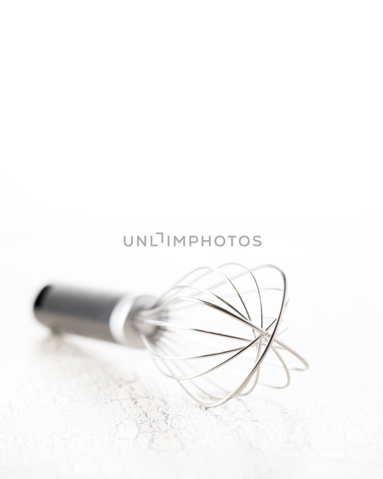 Artistic photograph of a simple kitchen wisk with an intentional shallow depth of field.