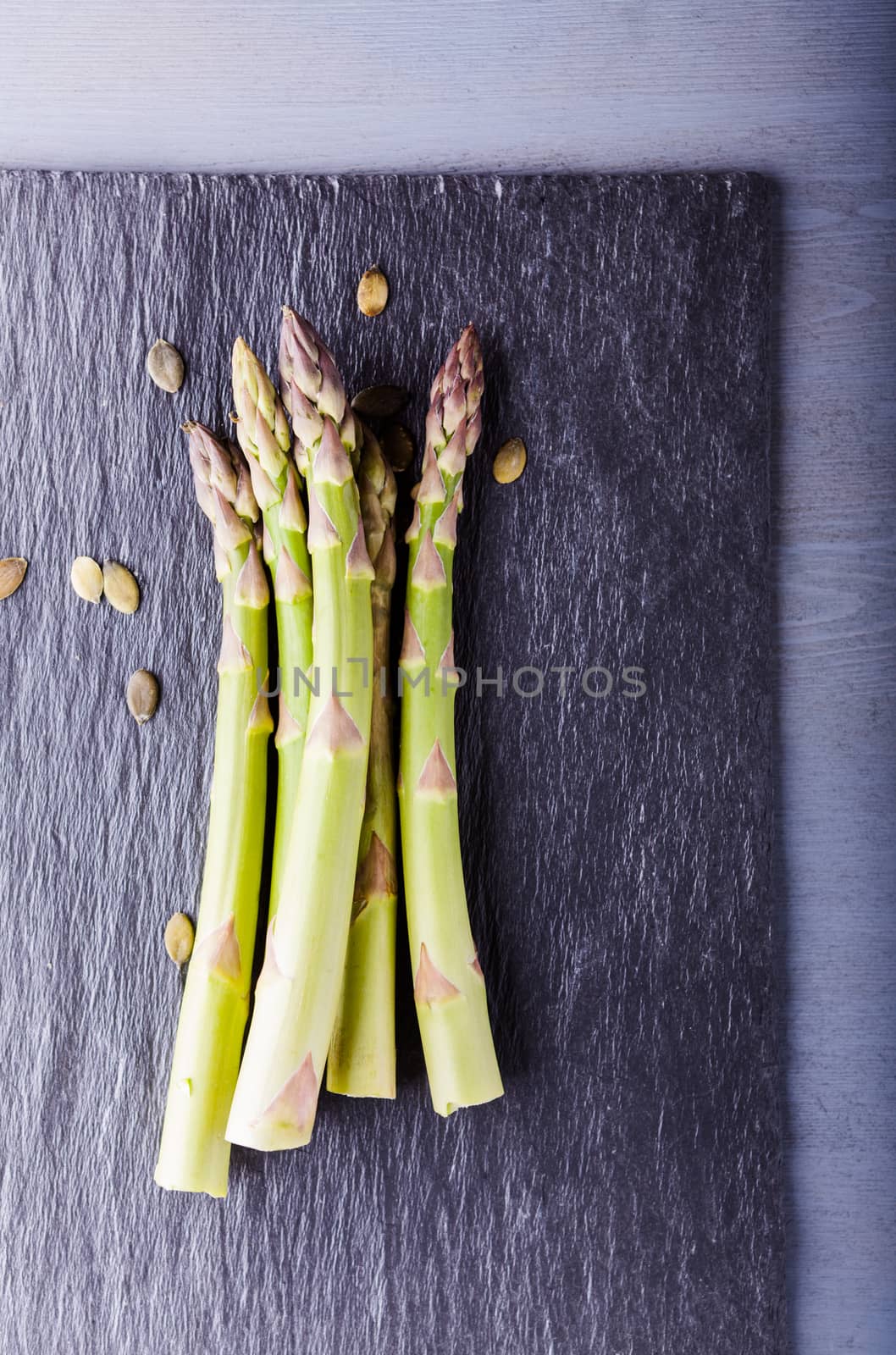 Fresh green Asparagus on a stone plate