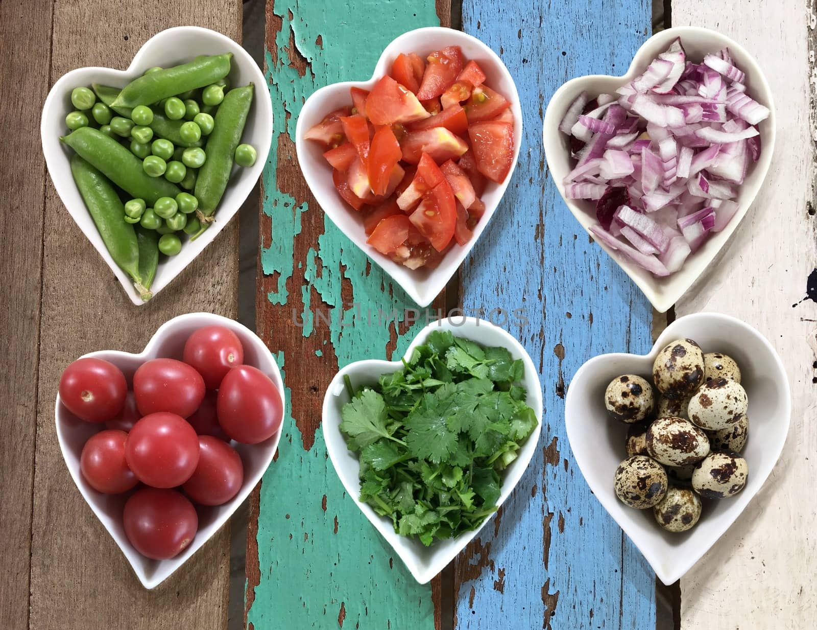 Background of diet food in heart shaped bowls set on old vintage wooden texture.