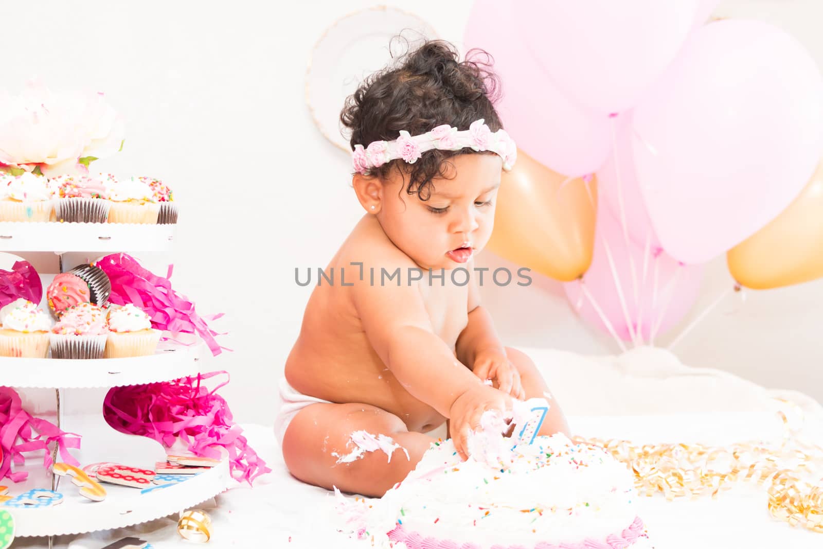 Young Baby Girl Celebrating Her First Birthday With Cake