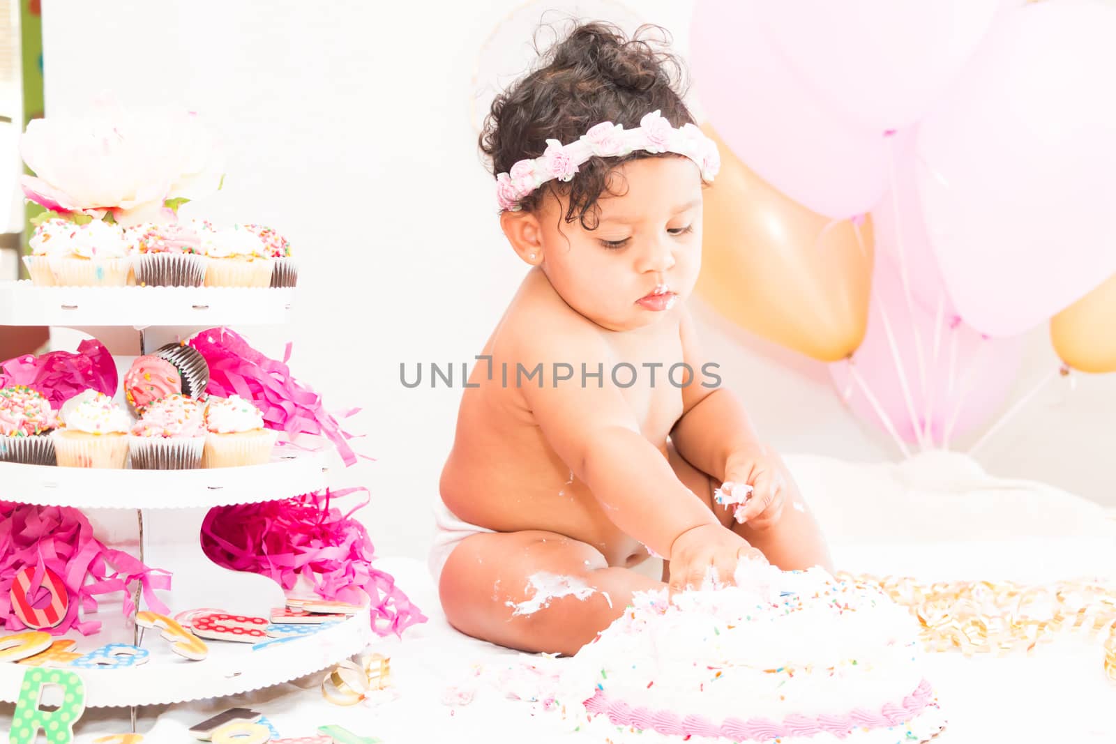 Young Baby Girl Celebrating Her First Birthday With Cake