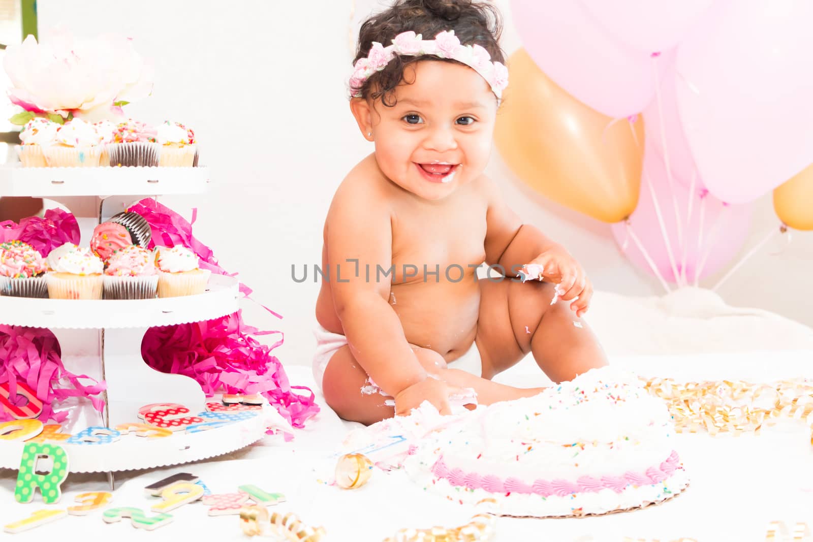 Young Baby Girl Celebrating Her First Birthday With Cake